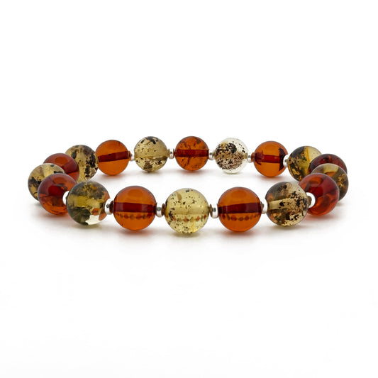 MUVERT, natūralaus gintaro apyrankė.
Poliruotos, šrato formos, natūralaus gintaro detalės su sidabro intarpais. 
Detalių diametras: 9 - 9.5 mm. 
Vidinis Ilgis: 16 - 21 cm pasirinktinai. 
Suverta ant elastingos, silikoninės gumos. 
Be užsegimo.