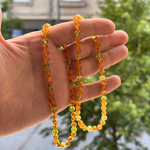 Gintaro Apyrankė Vaikams – Medaus Spalva ir Peridotas
Ši natūralaus Baltijos gintaro apyrankė vaikams ir paaugliams suverta iš šiltos medaus spalvos gintaro karoliukų ir švelniai žalio peridoto. Derinys ramus, harmoningas ir natūralus – tinkamas tiek kasdienai, tiek ypatingoms progoms, kai norisi šilto ir spalvingo akcento.

Savybės
100 % natūralus Baltijos gintaras – medaus spalvos.

Dekoratyvinis akmuo: peridotas.

Karoliukų išdėstymas: 3 gintaro karoliukai + 1 peridoto akmuo (ritminga seka).

Akmens kilm